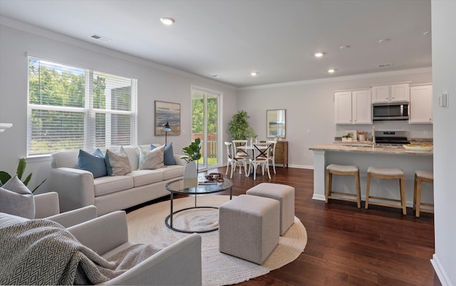 living room featuring visible vents, dark wood-style floors, recessed lighting, and ornamental molding