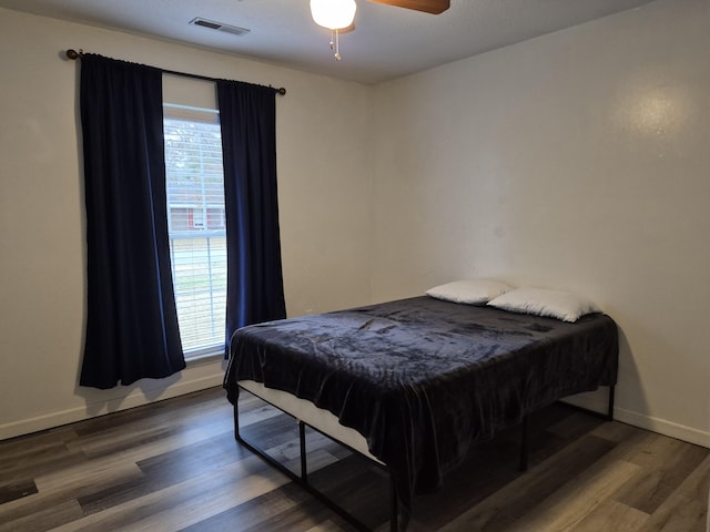 bedroom featuring dark wood-type flooring and ceiling fan