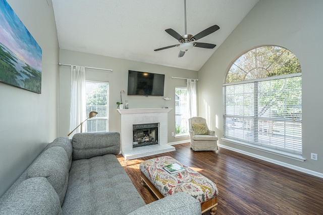 living room featuring ceiling fan, hardwood / wood-style floors, and high vaulted ceiling