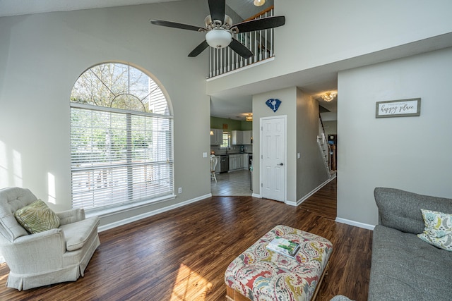 living room featuring ceiling fan, dark wood-type flooring, and high vaulted ceiling