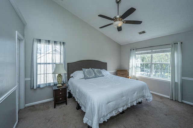 bedroom featuring multiple windows, ceiling fan, carpet floors, and vaulted ceiling