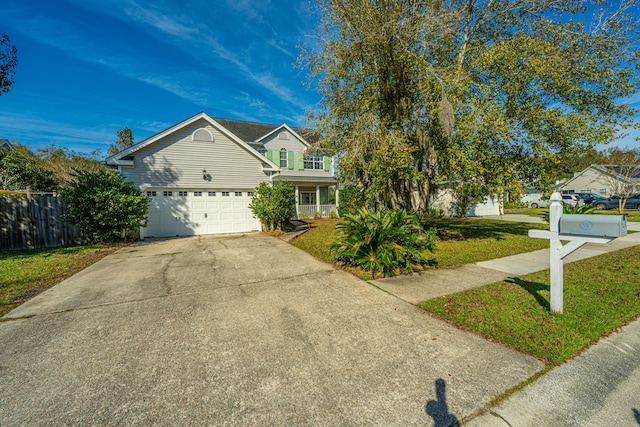 view of property with a porch, a garage, and a front yard