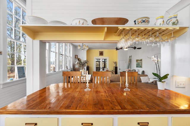 interior space with beamed ceiling and a notable chandelier