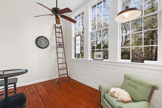 sitting room with wood-type flooring and ceiling fan