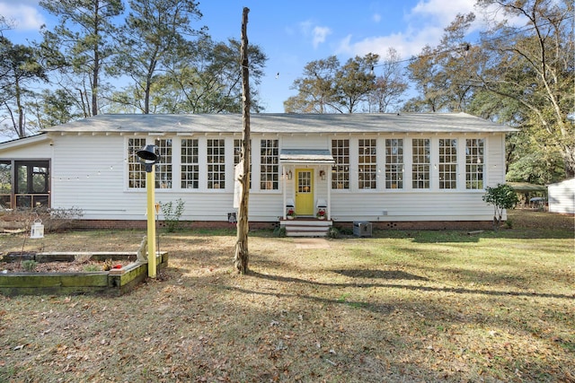 view of front of property with a front lawn and a sunroom