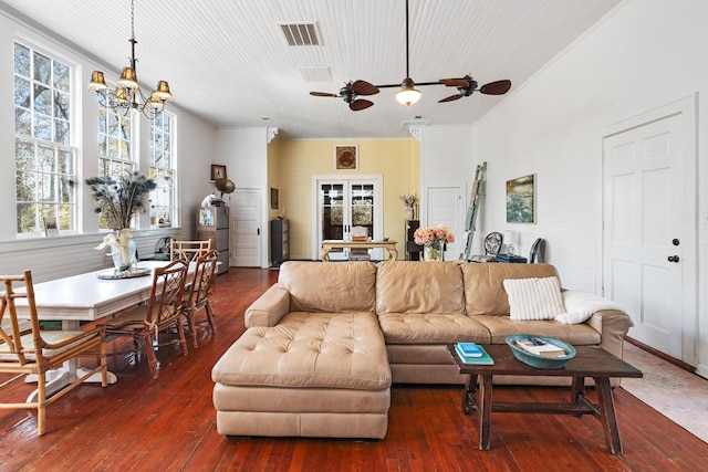 living room featuring dark hardwood / wood-style floors and ceiling fan with notable chandelier