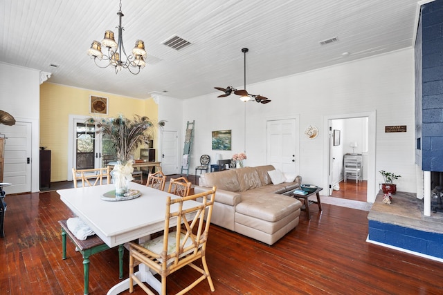 dining room with an inviting chandelier and dark wood-type flooring