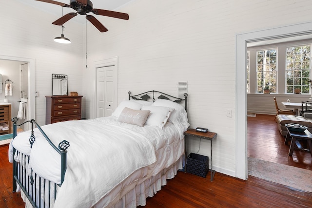 bedroom featuring ensuite bath, ceiling fan, a high ceiling, dark hardwood / wood-style flooring, and a closet