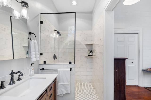 bathroom with vanity and tiled shower