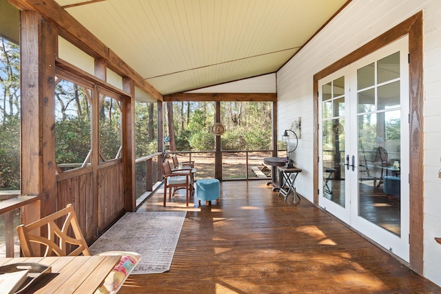 sunroom / solarium featuring vaulted ceiling, wooden ceiling, and french doors