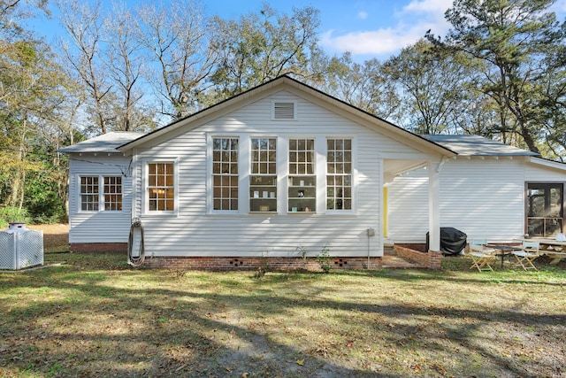 back of house with a yard