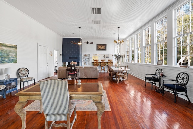 dining room featuring ceiling fan with notable chandelier and hardwood / wood-style floors