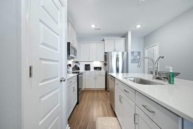 148 Omalley Dr, Summerville, SC 29483 - kitchen with light countertops, stainless steel appliances, a sink, visible vents, and white cabinets