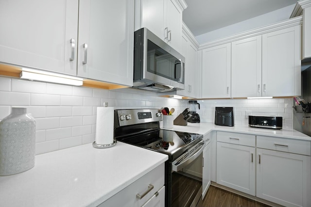 148 Omalley Dr, Summerville, SC 29483 - kitchen with light countertops, tasteful backsplash, dark wood-type flooring, white cabinets, and appliances with stainless steel finishes