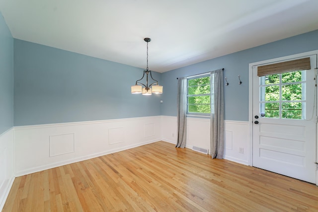 7 Plainfield Dr, Charleston, SC 29407 - unfurnished dining area featuring light wood-type flooring, wainscoting, and a chandelier