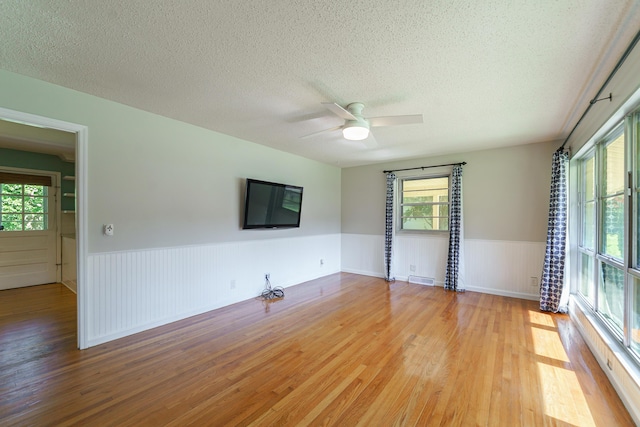 7 Plainfield Dr, Charleston, SC 29407 - spare room with light wood finished floors, wainscoting, healthy amount of natural light, ceiling fan, and a textured ceiling