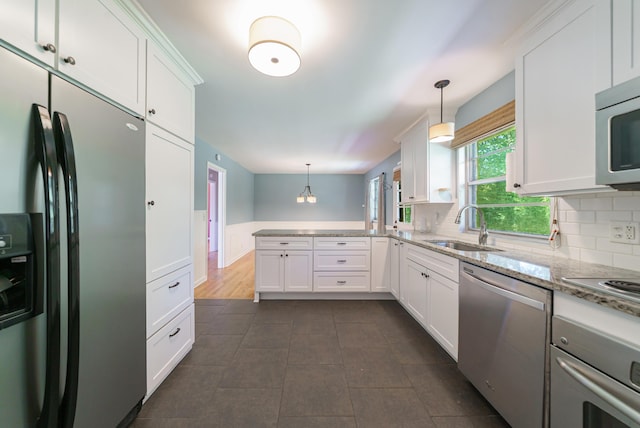 7 Plainfield Dr, Charleston, SC 29407 - kitchen featuring stainless steel appliances, a peninsula, white cabinets, light stone countertops, and hanging light fixtures