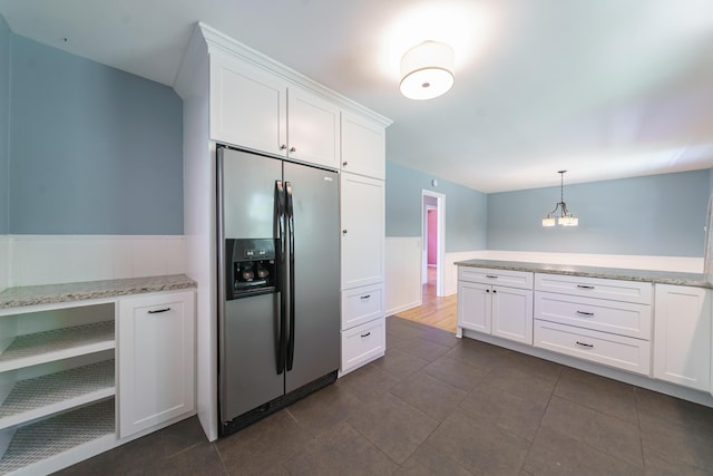 7 Plainfield Dr, Charleston, SC 29407 - kitchen with stainless steel refrigerator with ice dispenser, wainscoting, white cabinetry, hanging light fixtures, and dark tile patterned floors