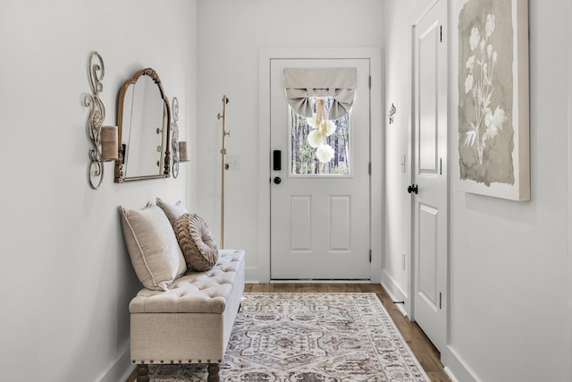 foyer with baseboards and wood finished floors