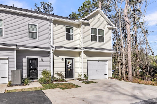 view of property featuring an attached garage and driveway