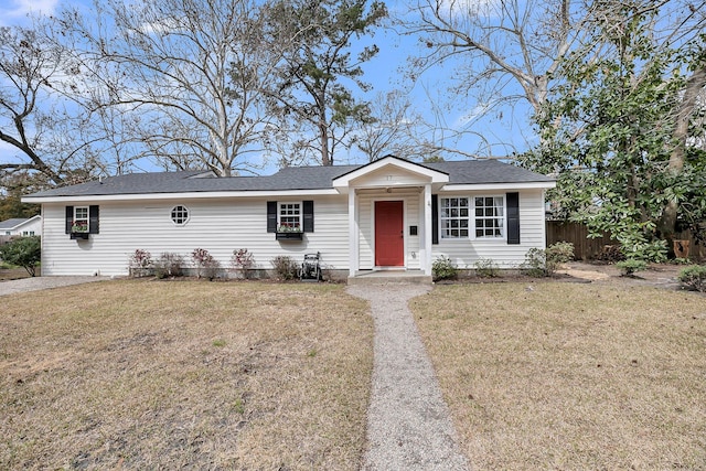 single story home featuring fence and a front lawn