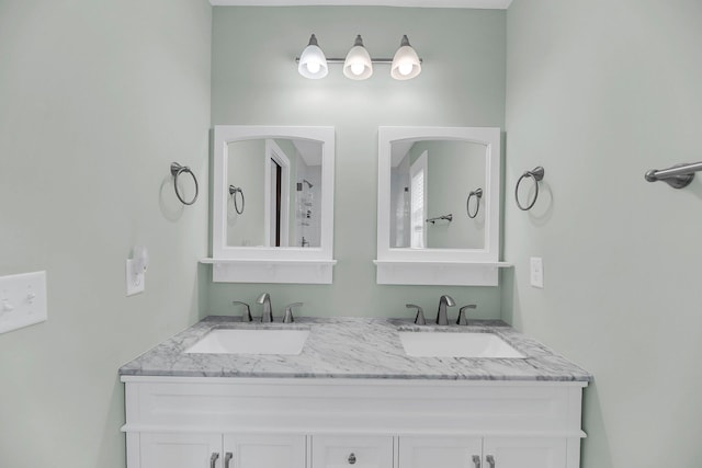 full bathroom with a sink and double vanity