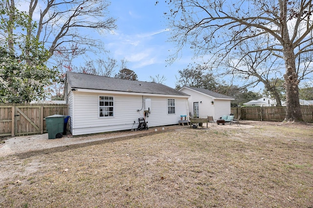 back of house with a patio area, a fenced backyard, and a yard