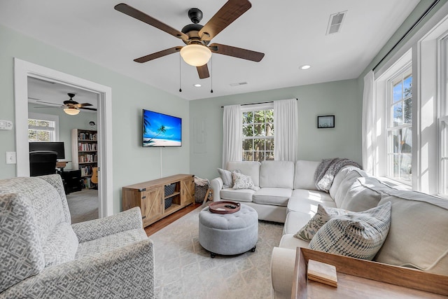 living area featuring visible vents and recessed lighting