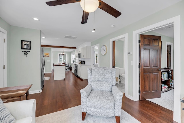 living room featuring baseboards, visible vents, ceiling fan, dark wood-type flooring, and recessed lighting