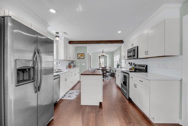 kitchen featuring recessed lighting, dark wood-style flooring, white cabinets, appliances with stainless steel finishes, and tasteful backsplash