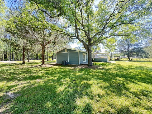 view of grassy yard with cooling unit
