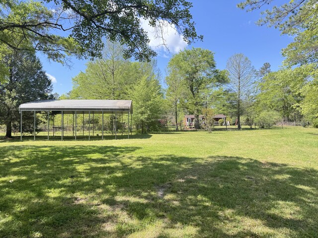 view of green lawn featuring a detached carport