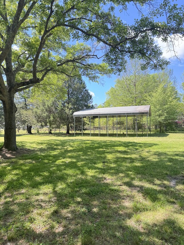 view of community with a carport and a yard