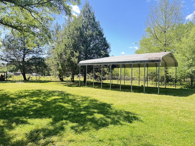 view of community featuring a yard and a carport