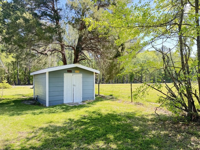 view of shed with a forest view