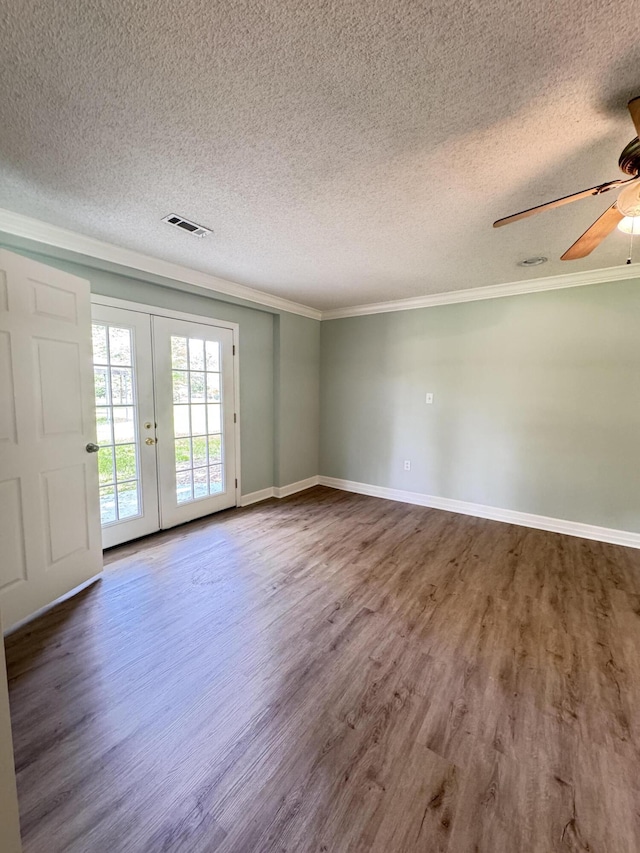 unfurnished room with ornamental molding, wood finished floors, a ceiling fan, a textured ceiling, and french doors