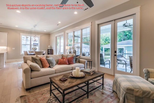 living room with crown molding, ceiling fan, and light wood-type flooring