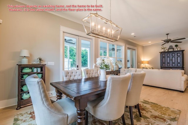 dining room featuring ornamental molding, ceiling fan, and light wood-type flooring