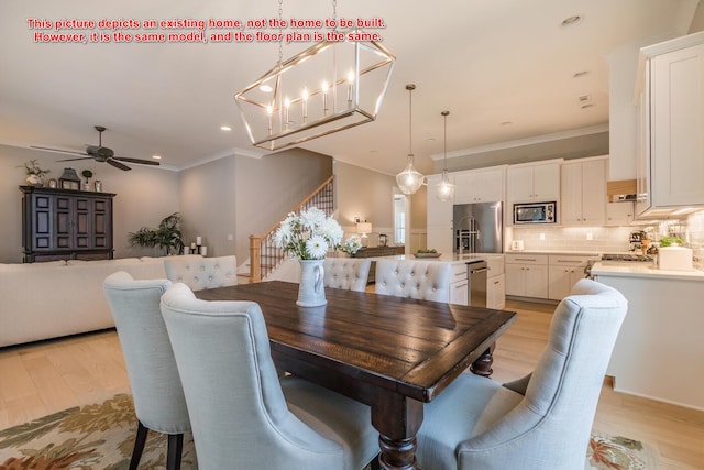 dining area with ceiling fan, ornamental molding, and light hardwood / wood-style flooring