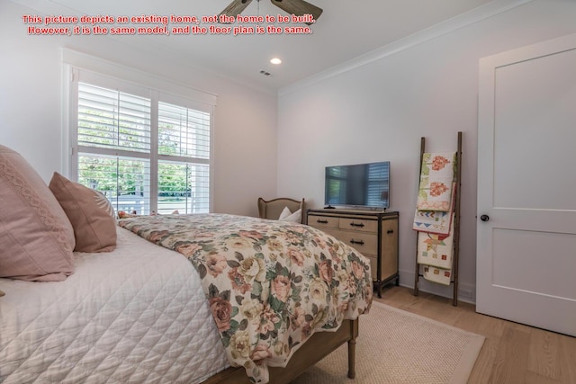 bedroom featuring crown molding, light hardwood / wood-style floors, and ceiling fan