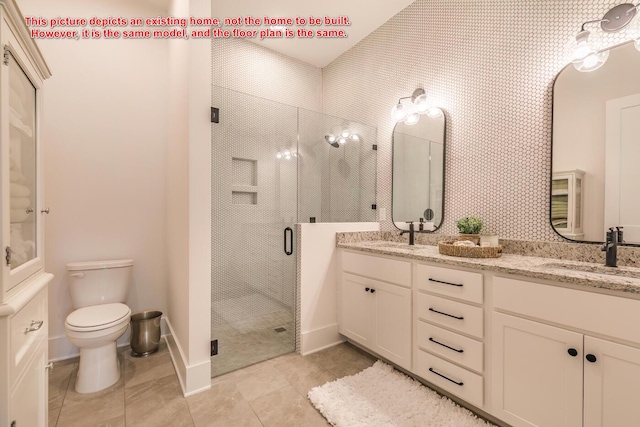 bathroom featuring vanity, a shower with shower door, and toilet