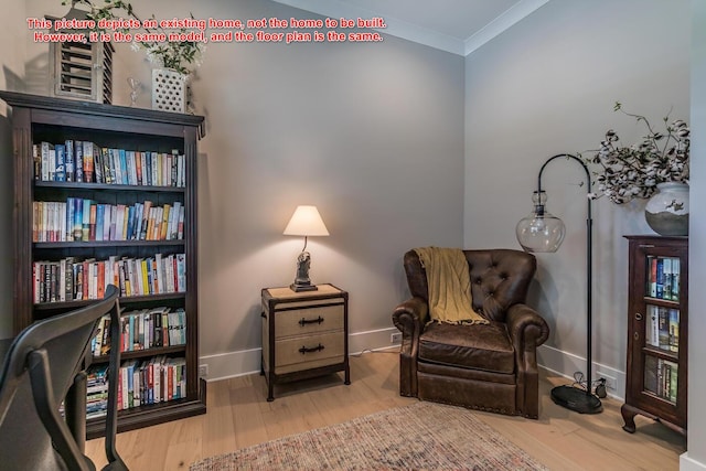 living area featuring crown molding and hardwood / wood-style floors