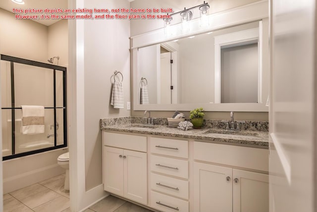 full bathroom featuring vanity, combined bath / shower with glass door, tile patterned floors, and toilet