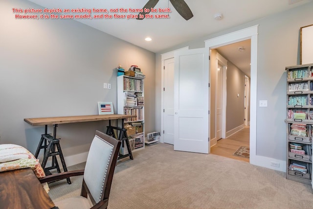 carpeted office space featuring ceiling fan