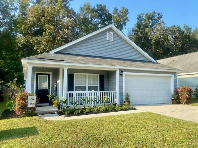 view of front of property with a porch, a front yard, and a garage