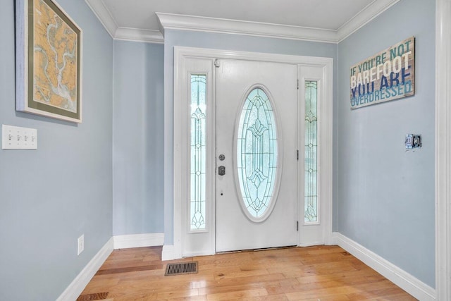 entryway featuring light hardwood / wood-style floors, plenty of natural light, and crown molding