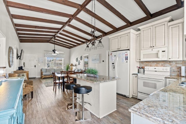 325 N 58th Ave, North Myrtle Beach, SC 29582 - kitchen with white appliances, ceiling fan, a center island, light wood-style flooring, and light stone counters