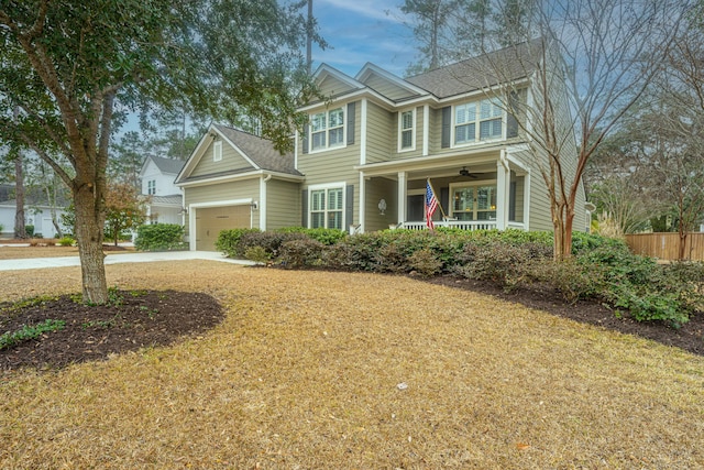 view of front of house featuring ceiling fan, a garage, and a front lawn