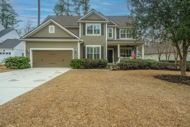 view of front facade featuring a garage, a front yard, and a porch