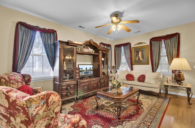 living room featuring ceiling fan and hardwood / wood-style flooring